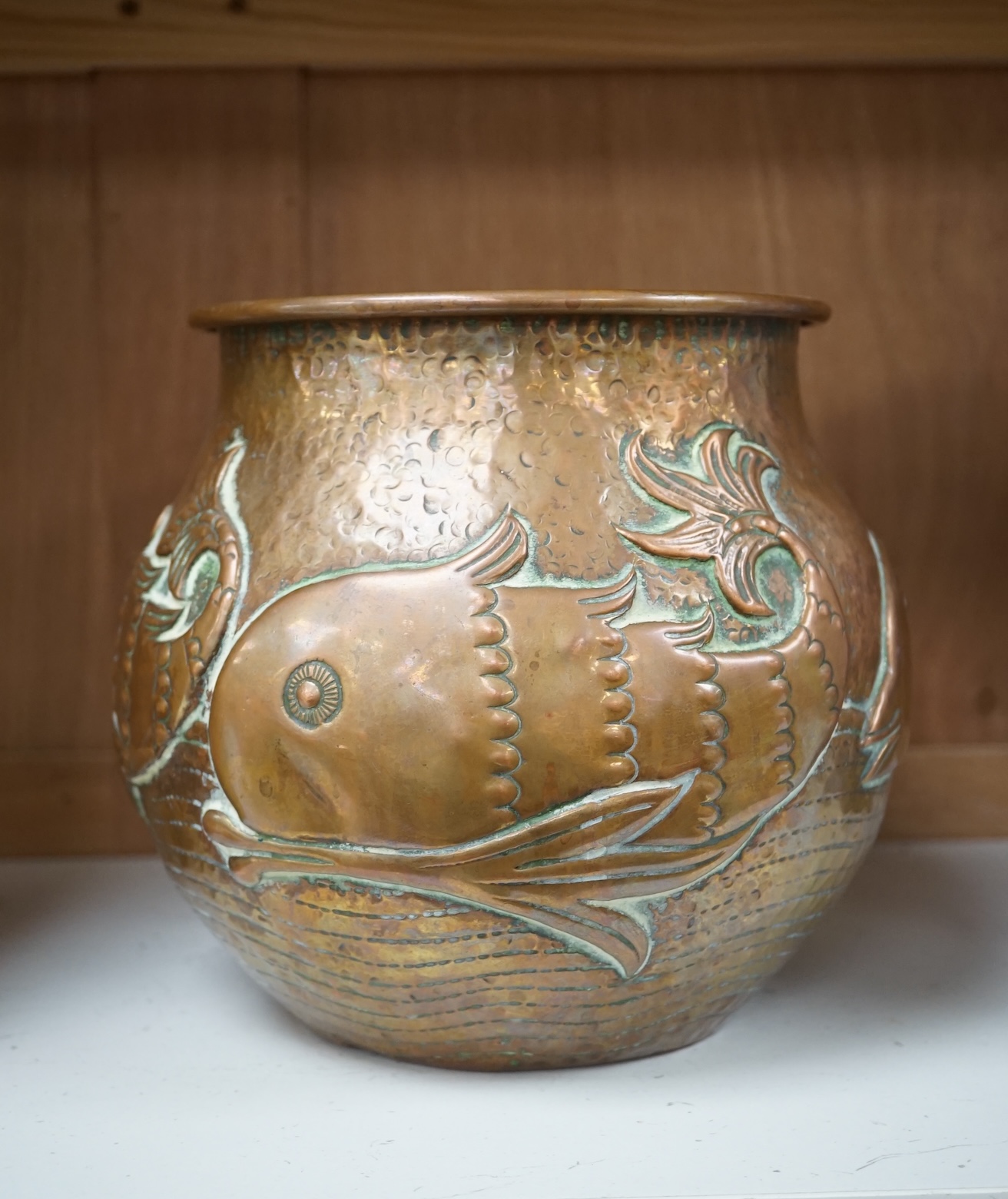 A Newlyn Arts & Crafts jardiniere by John Pearson, decorated with four different fish, signed and numbered 2473. Condition - minor dents, essentially good